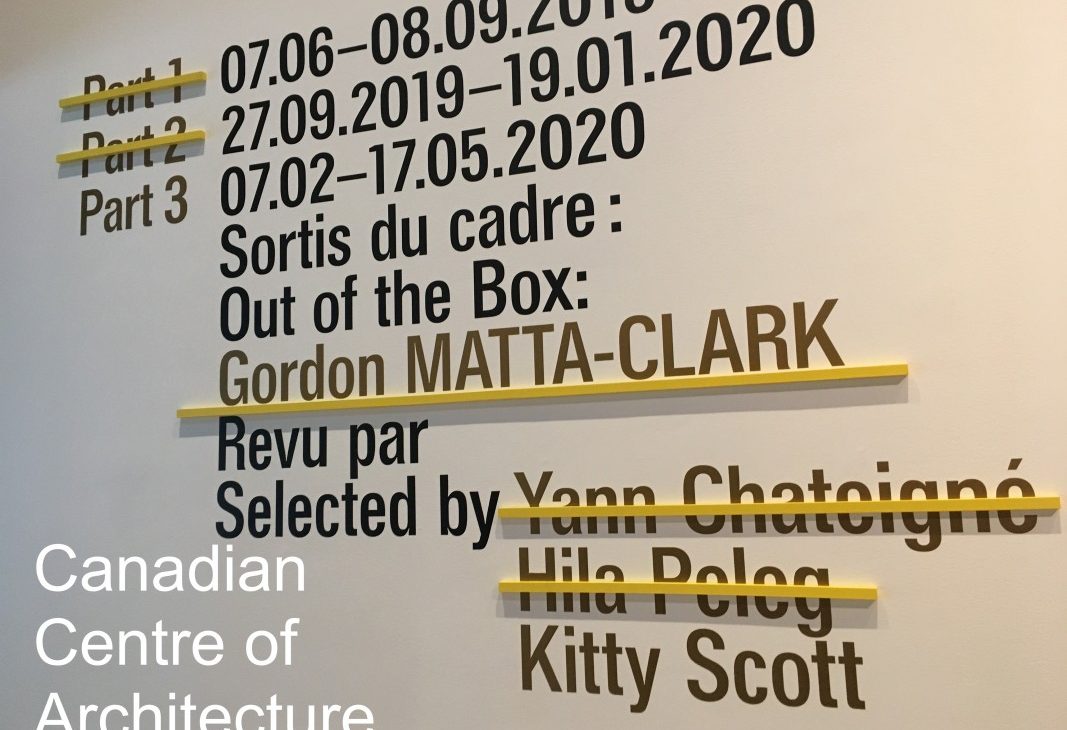 Black vinyl lettering on a white wall with dates; Part 1 and part 2 crossed out with yellow dash; part 3 of the programme selected by Kitty Scott includes: Gordon Matta-clark