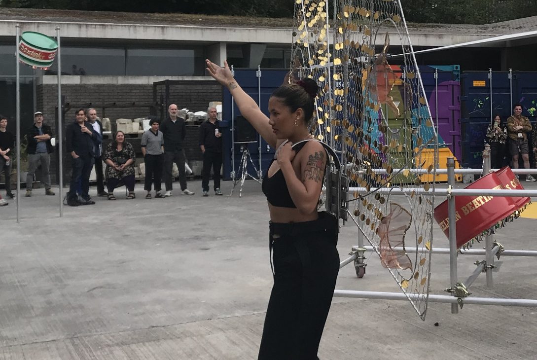 Performer Jessica Harris wearing the large wing sculpture during the performance, Ashanti Harris exhibition