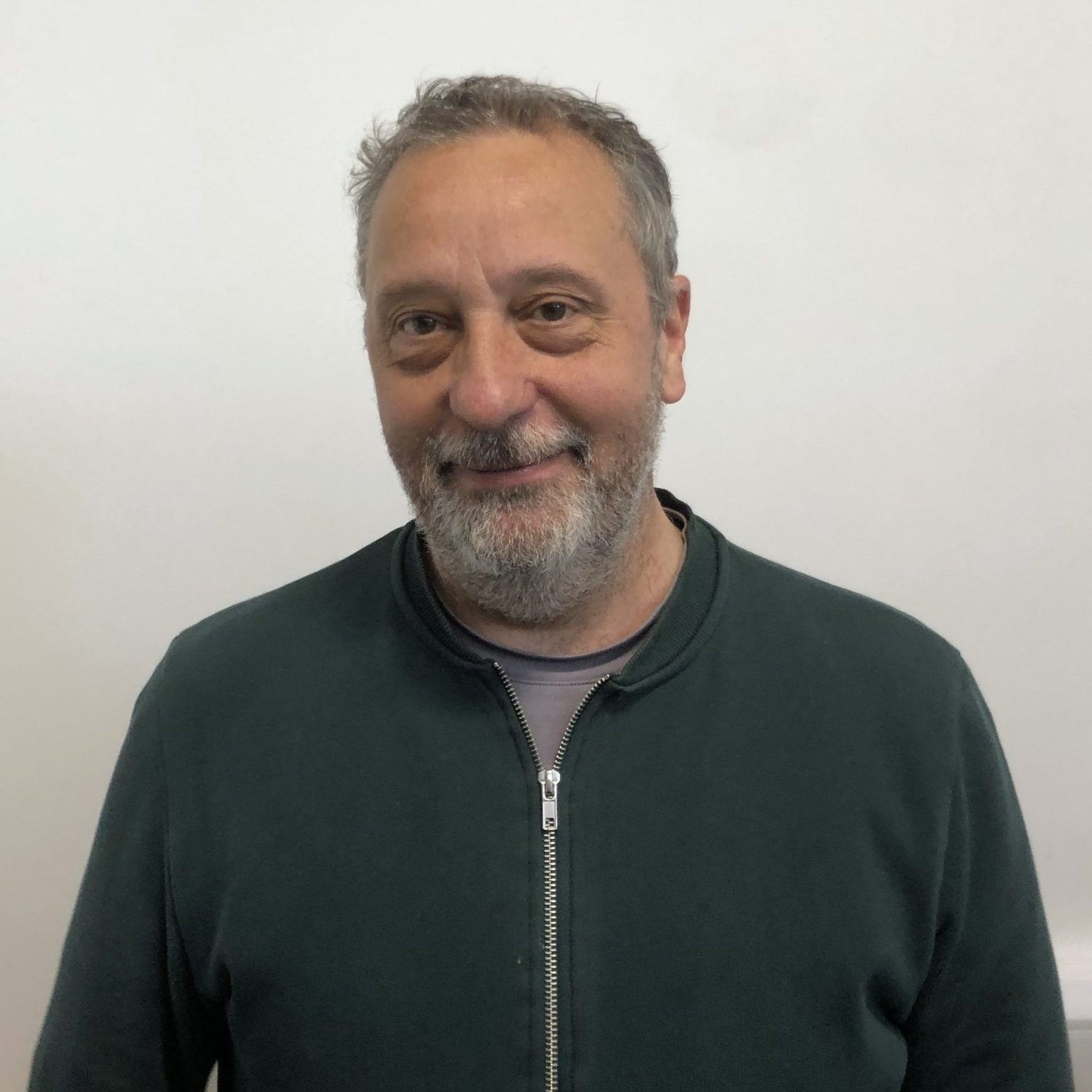 Richard Moore standing against a white wall.