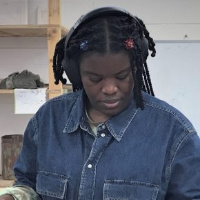 Dr Sequoia Barnes working on coil building at a desk in ESW Ceramics Workshop