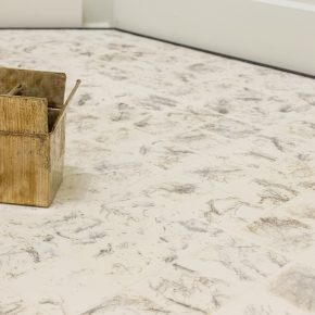 View onto white and grey floor with sculpture of a box at top left by Meabh Breathnach.