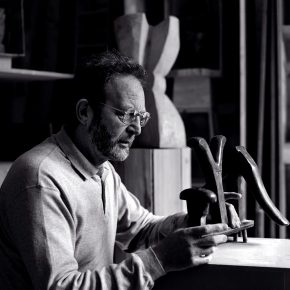 Black and white portrait of Bill Scott working in his studio taken by Trevor Yerbury.